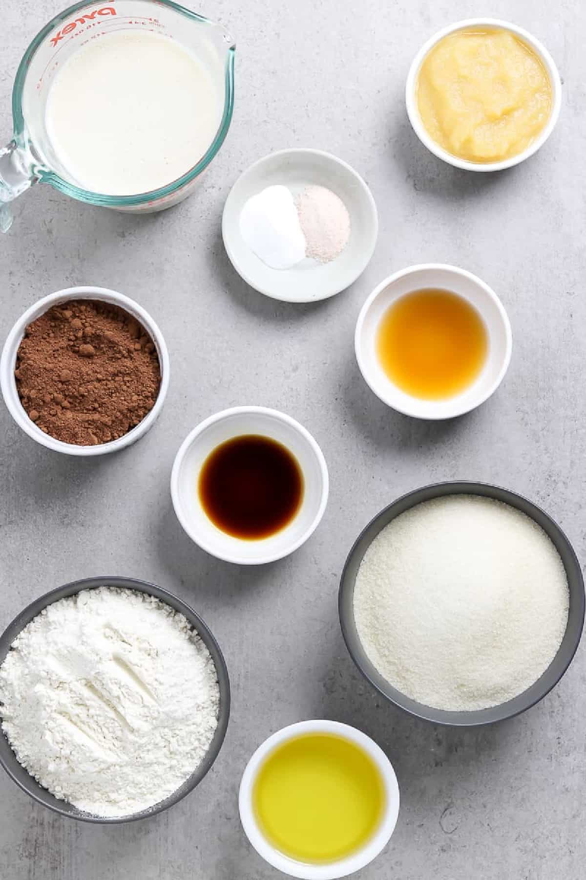 All the ingredients to make the cake batter on a stone table top. 