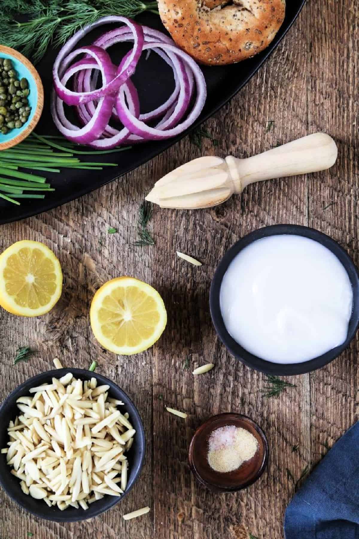 Ingredients to make vegan cream cheese on a wood table. 