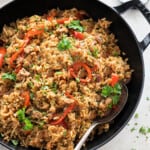 spicy sausage rice in a black skillet.