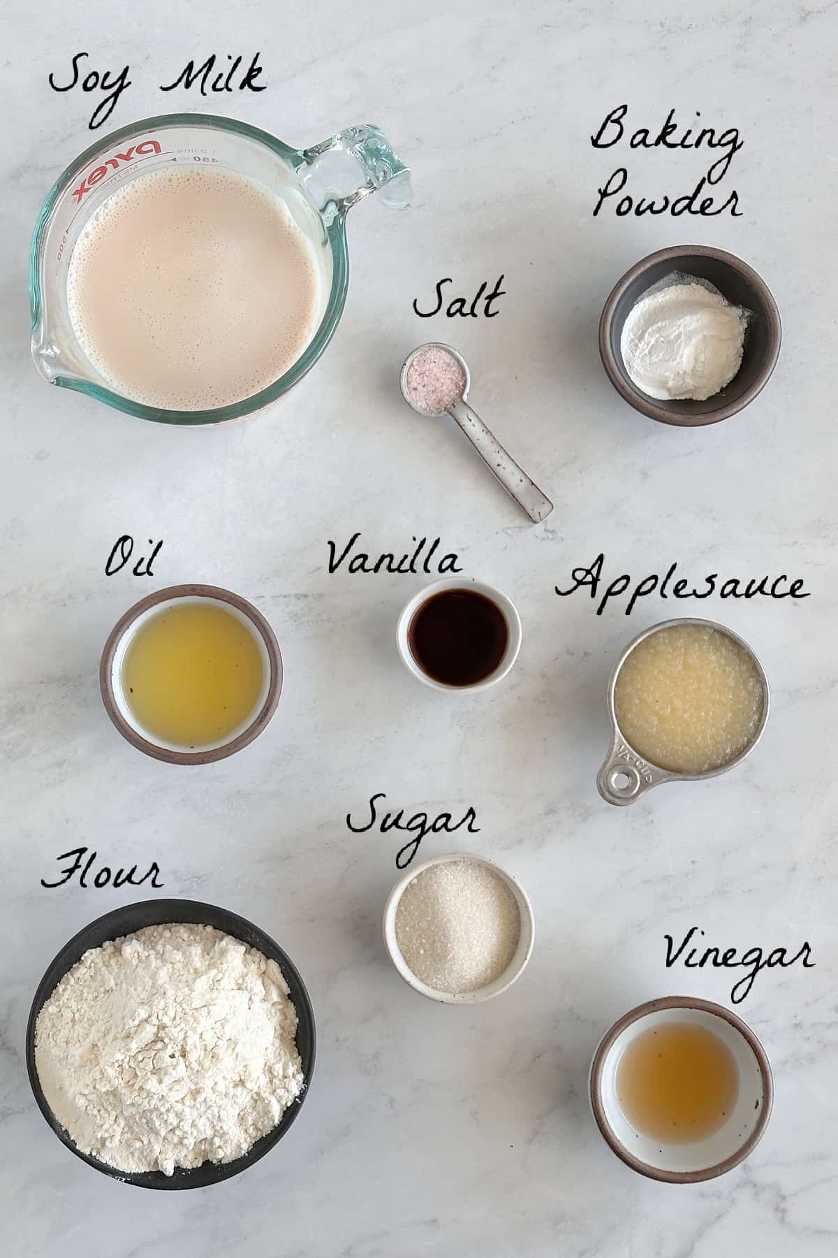 Ingredients to make waffles on a marble table top.