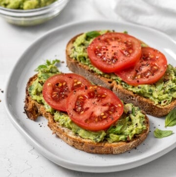 two pieces of white bean avocado toast on a plate.