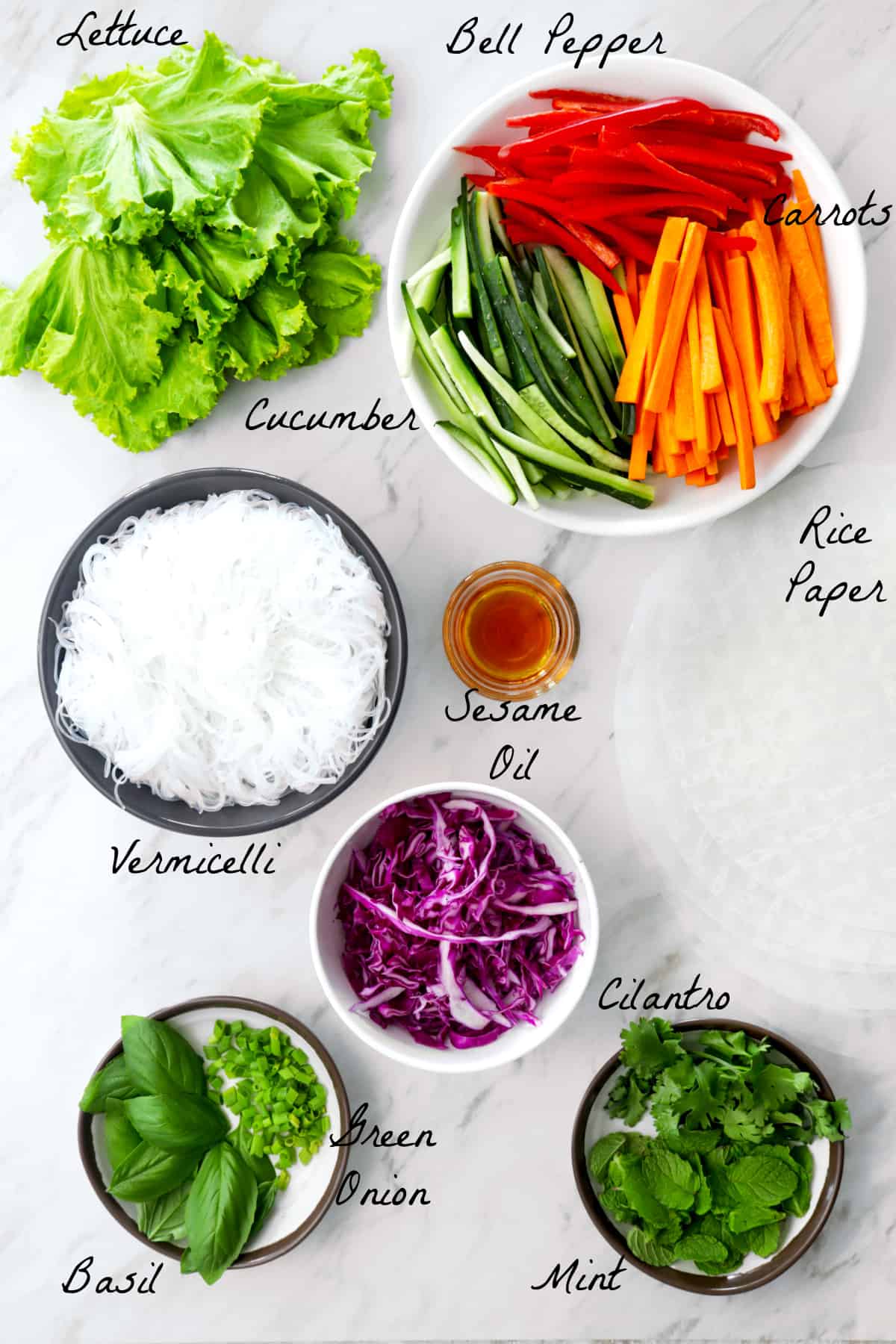Ingredients to make summer rolls on a marble table top.