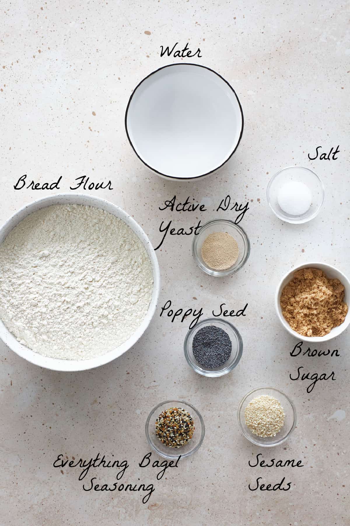 Ingredients to make the bagel dough on a stone table top. 