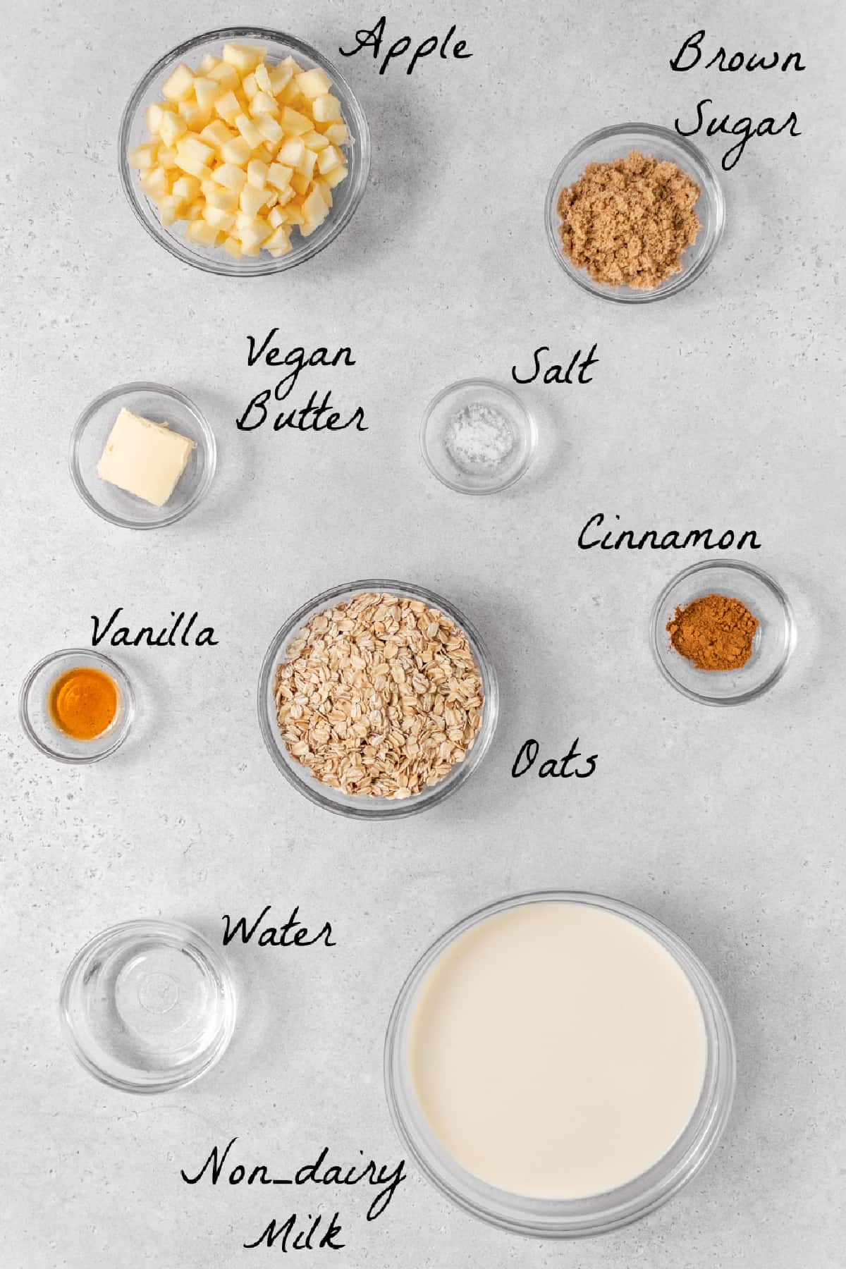 Ingredients to make the oatmeal recipe on a stone table top. 