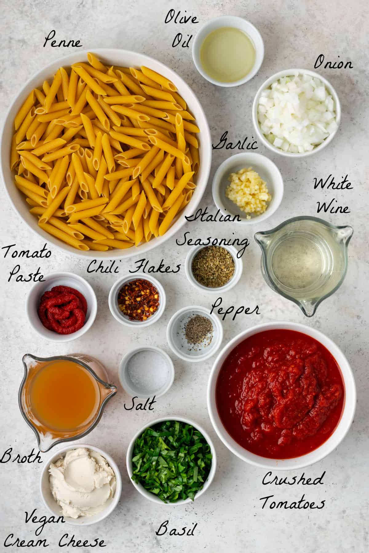 ingredients to make pasta displayed on a stone table top.