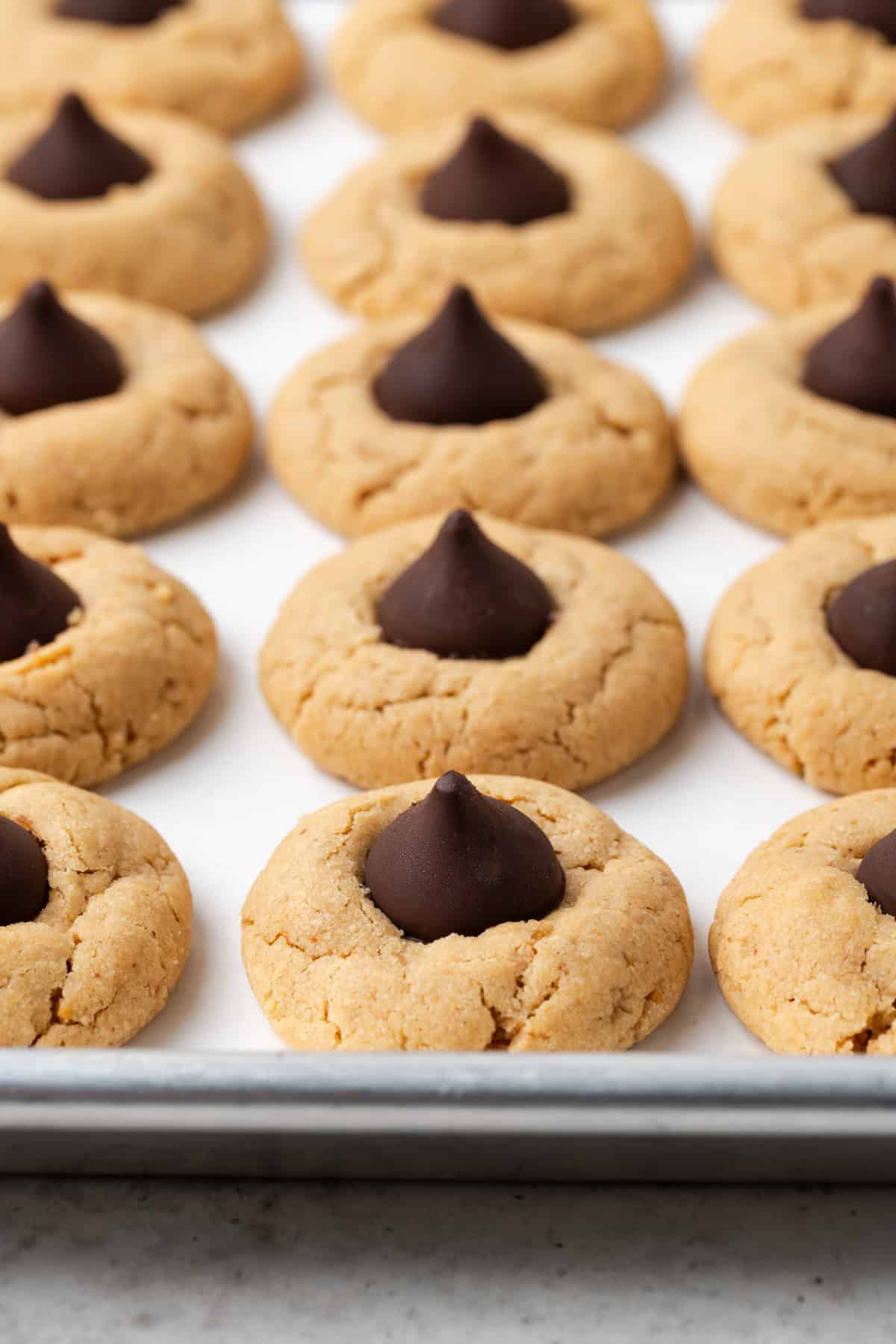 closeup view of vegan peanut butter blossoms on a baking sheet. 