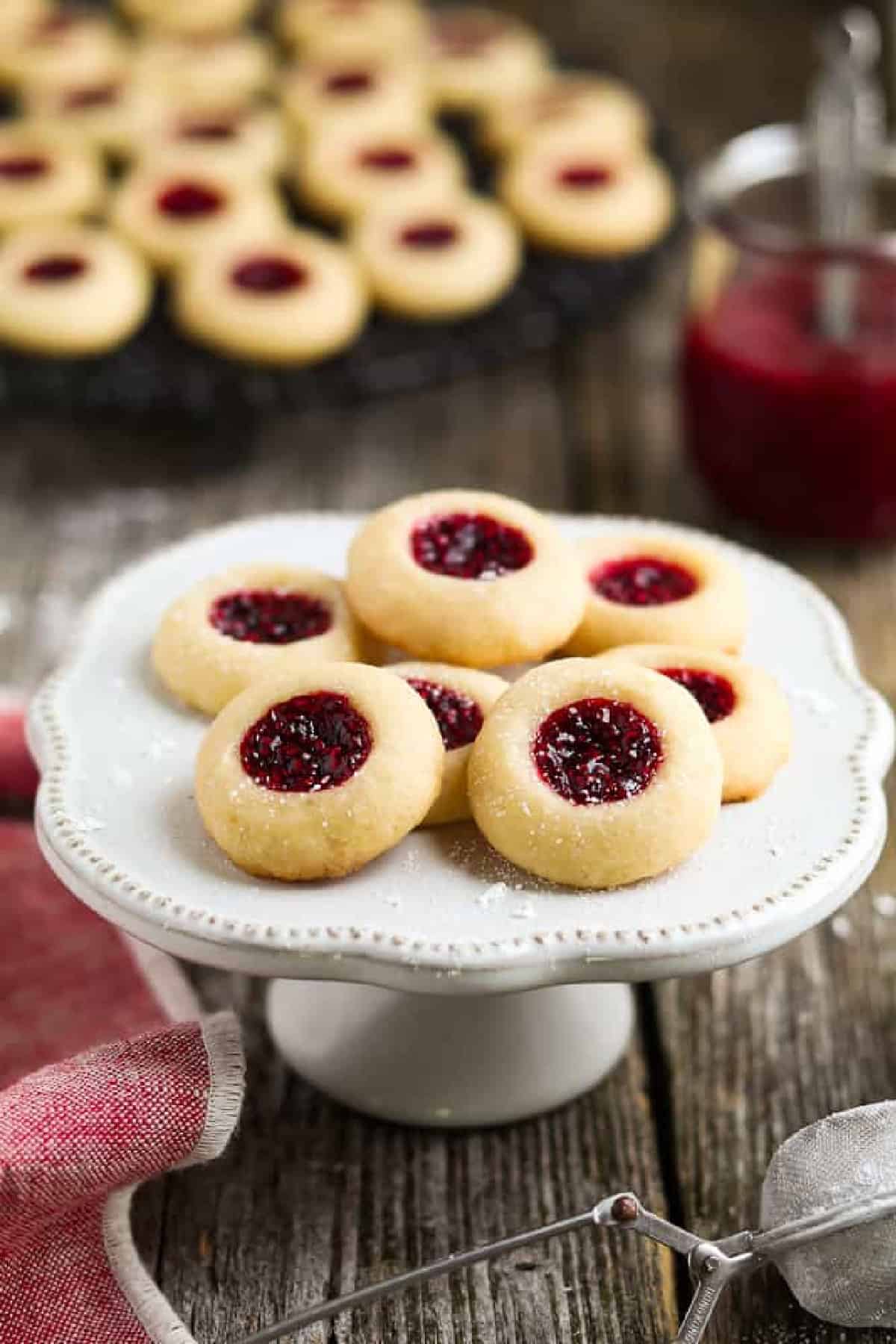 thumbprint cookies on a cake stand. 