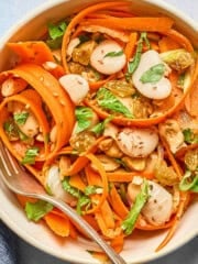 carrot salad in a a white bowl.