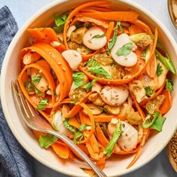 carrot salad in a a white bowl.