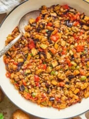 Close up view of eggplant caponata in a pan.