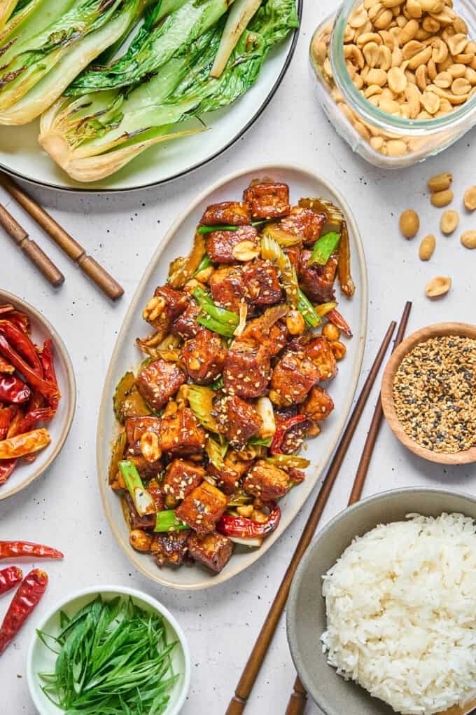 tofu on dish with rice and veggies on the side.