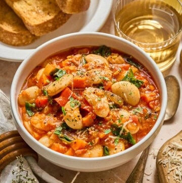 bowl of butter bean stew with bread on the side.
