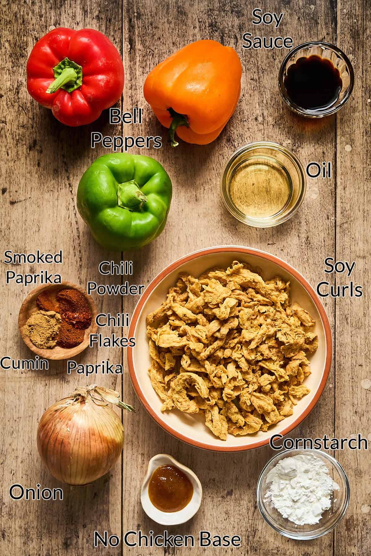 Ingredients for make fajitas on a wood table top.