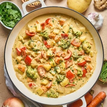 overhead view of vegan Thai yellow curry in a white pan.