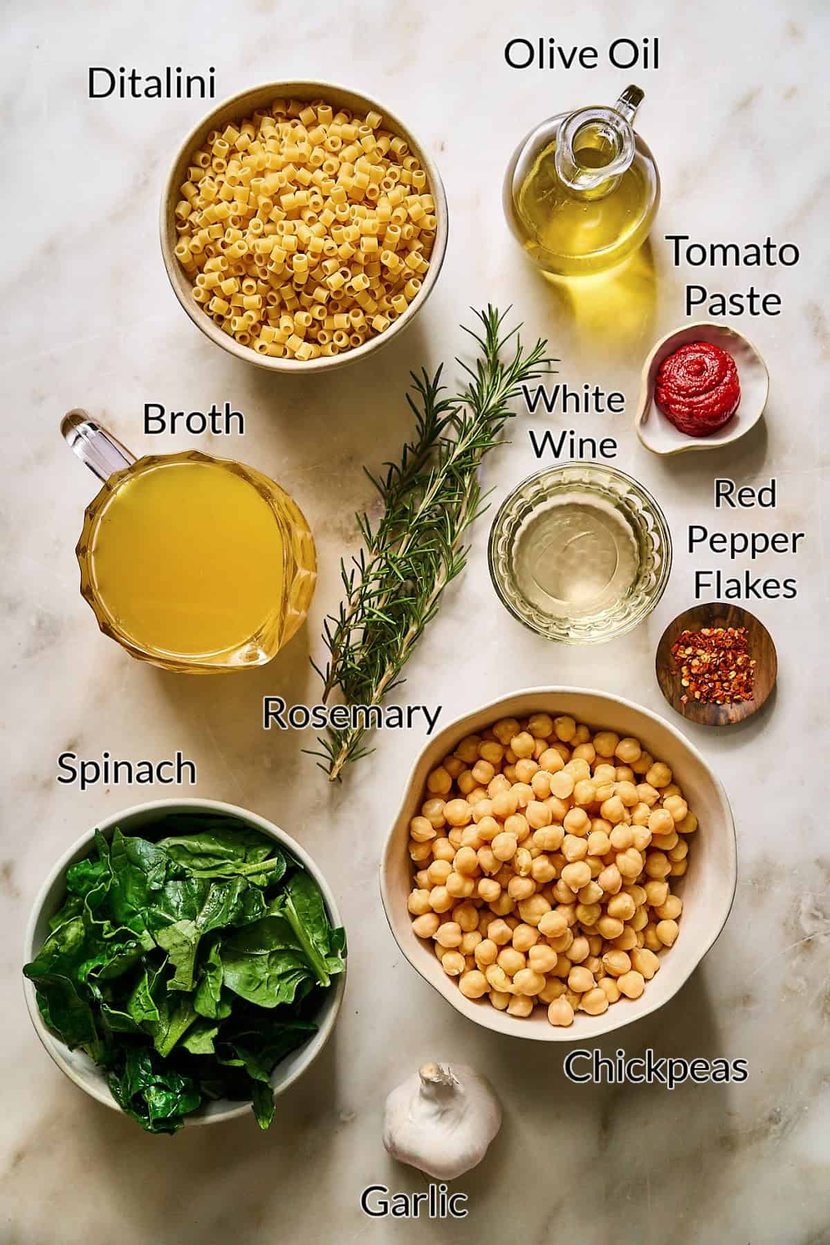 ingredients to make the pasta e ceci on a stone table top.