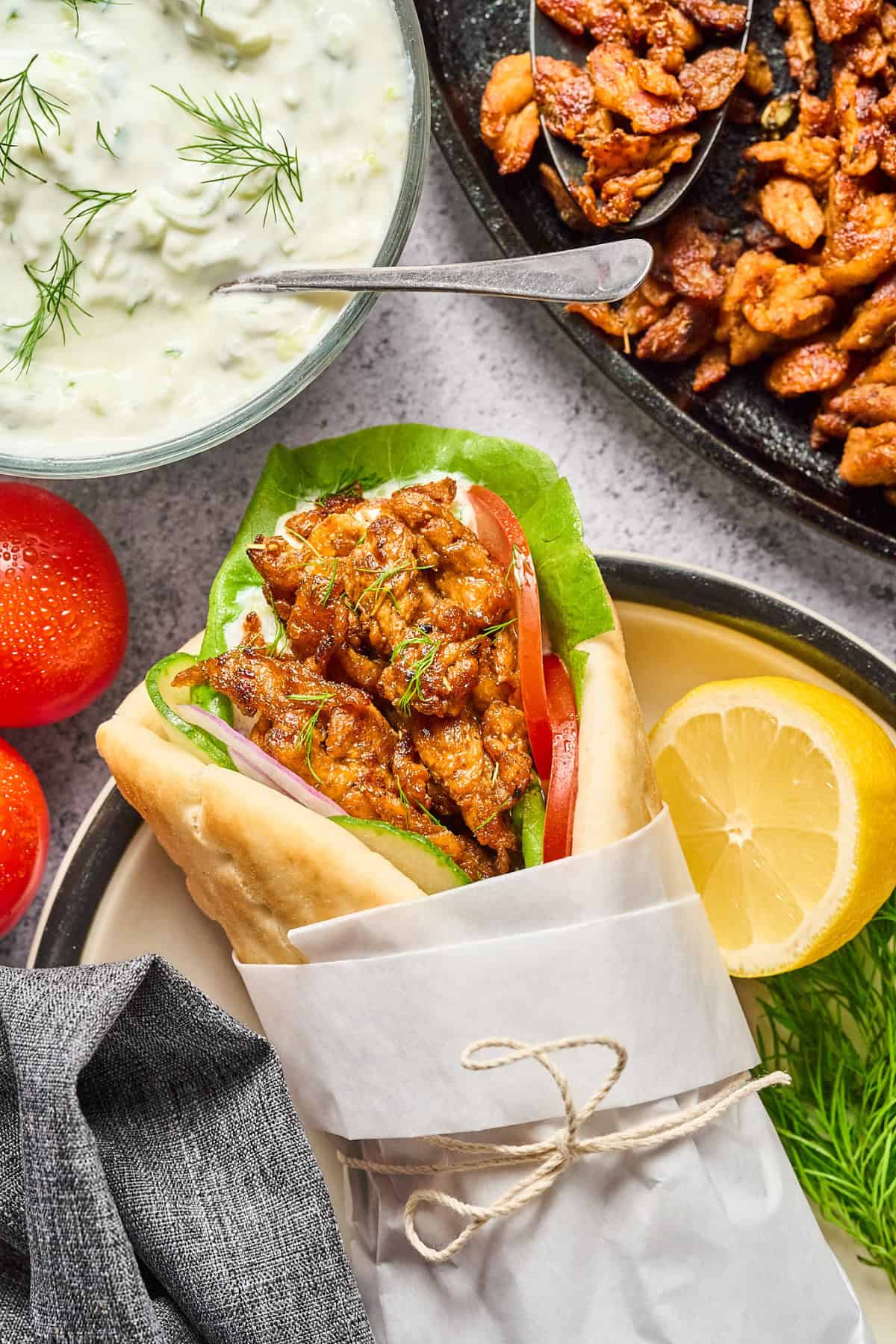 vegan gyros on plate with tzatziki and soy curls on the side.