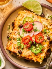 overhead view of a piece of vegan enchilada casserole on a plate.
