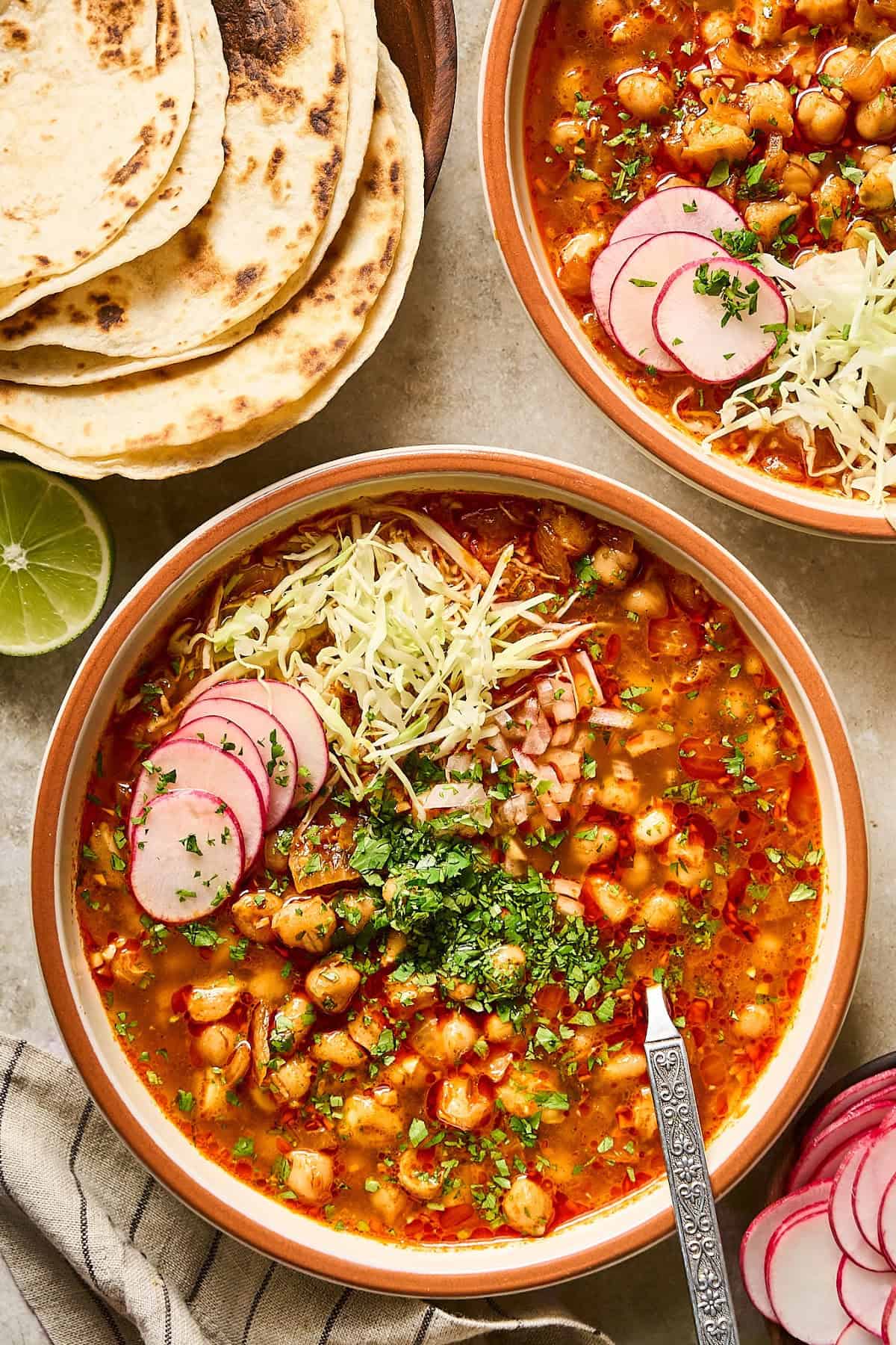 Overhead view of two bowls of vegan posole on a table.