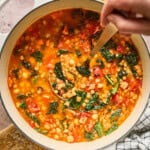 overhead view of fully cooked Italian lentil soup in a pot.