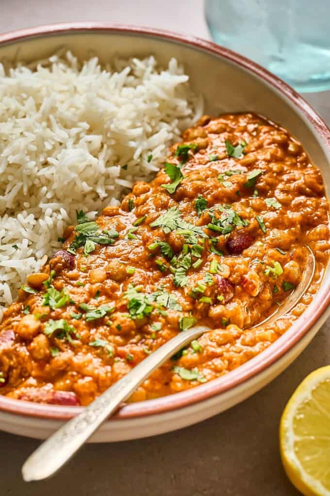 side view of cooked lentils in a bowl.