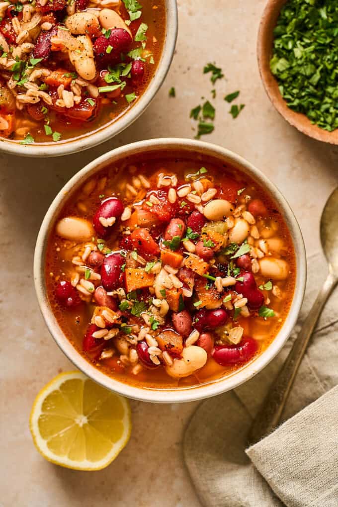 overhead view of two bowls of soup on a table.