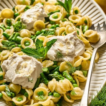 overhead view of vegan lemon ricotta pasta on a serving tray.
