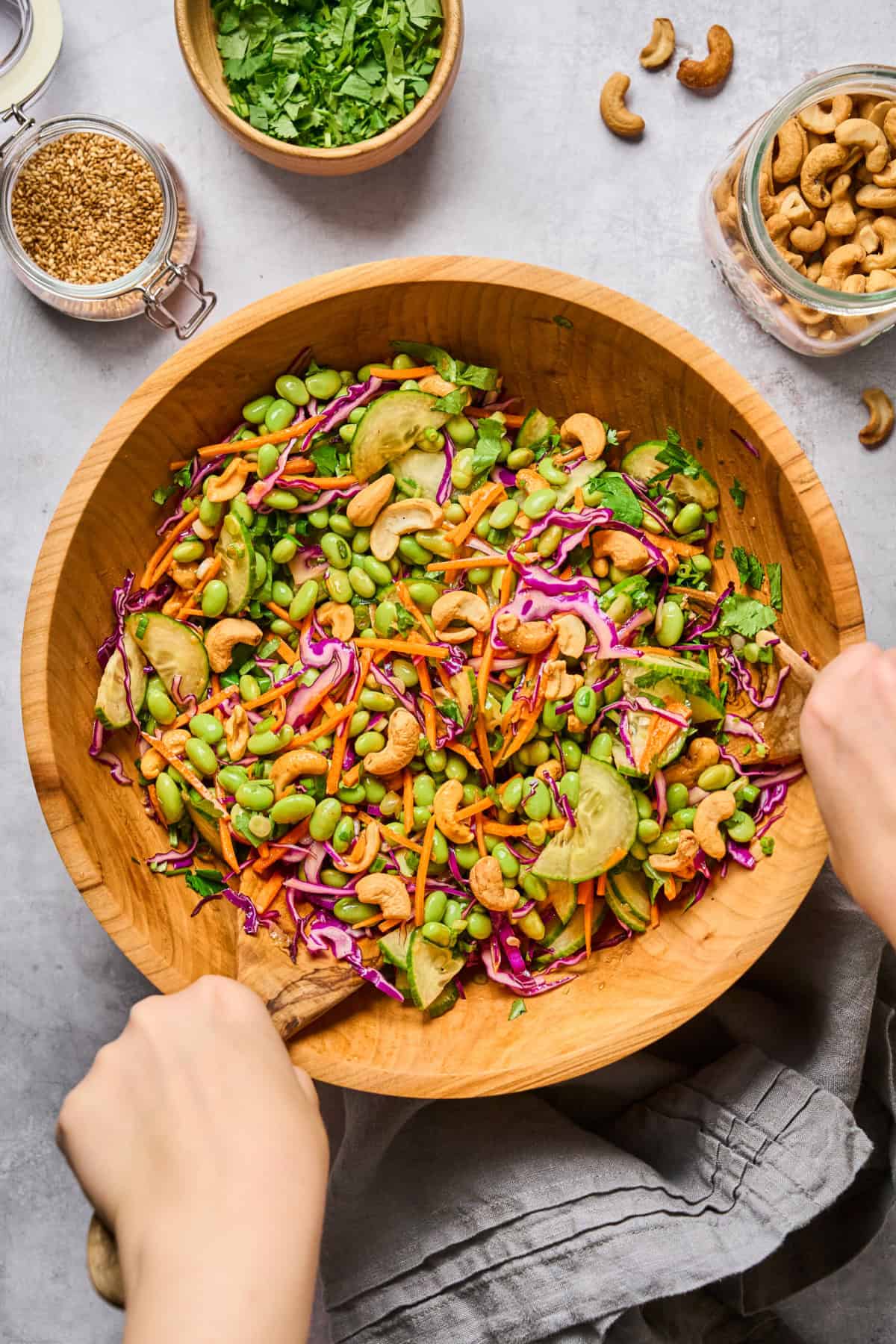overhead view of a fully assembled edamame salad in a wooden bowl.