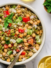 fully assembled lentil salad in a white bowl.