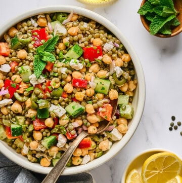 fully assembled lentil salad in a white bowl.