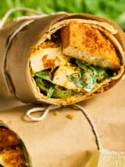 closeup view of a vegan chicken caesar wrap cut in half.