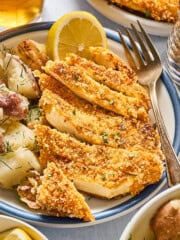 tofu schnitzel with potato salad on a plate.