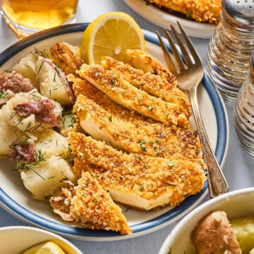 tofu schnitzel with potato salad on a plate.